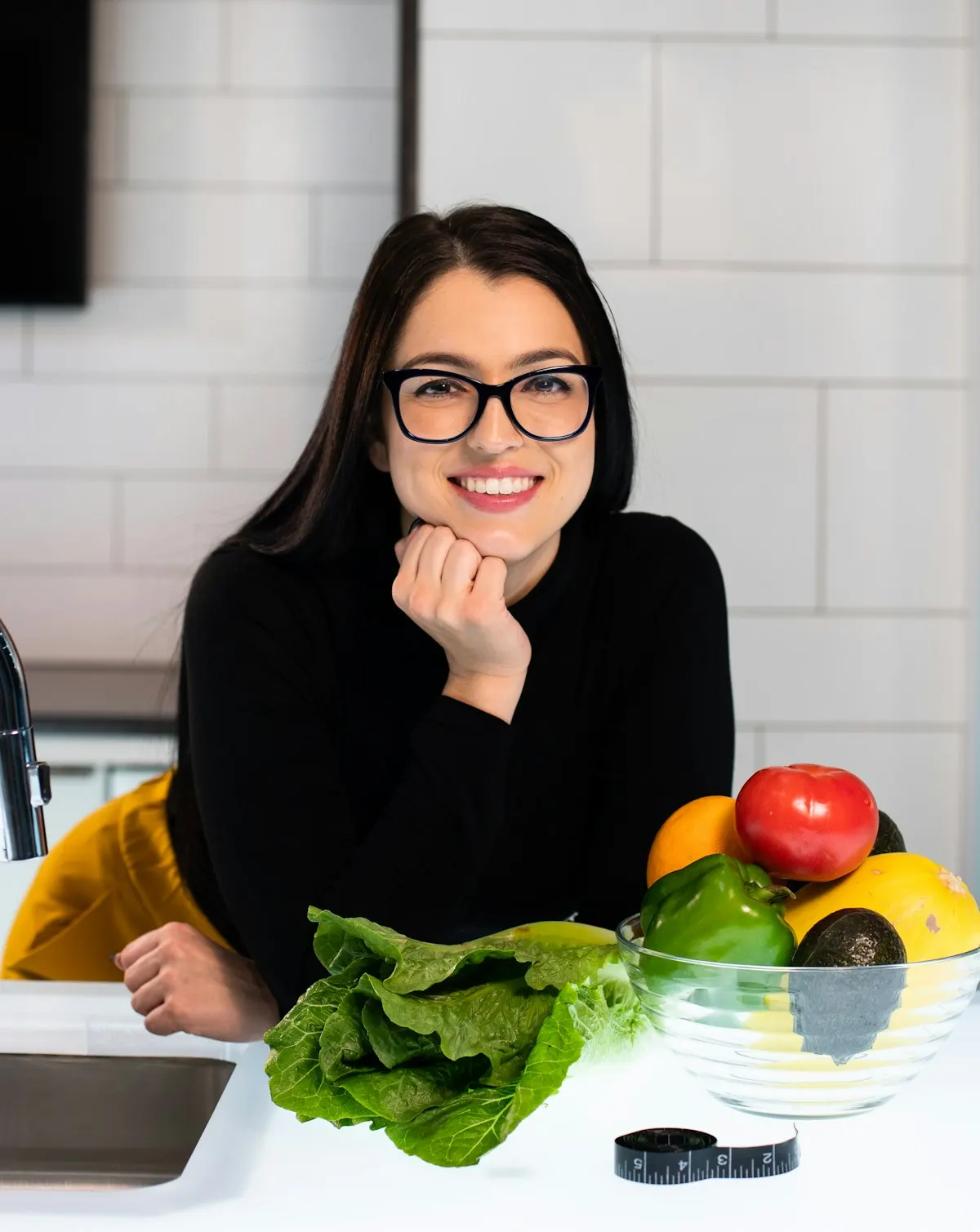 Paciente sonriendo con verdura fresca en la cocina